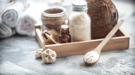 Spa still life with fresh coconut and body care products on light background, spa therapy conceptの写真素材