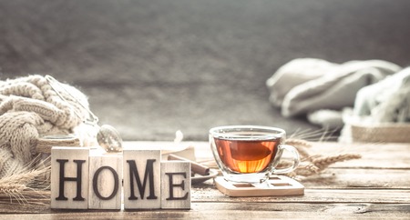 Still life home comfort with a Cup of tea and wooden letters home, the concept of comfort and home atmosphereの写真素材