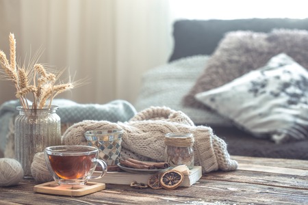 Still life details of home interior on a wooden table with a Cup of tea, the concept of coziness and home atmosphere .Living roomの写真素材