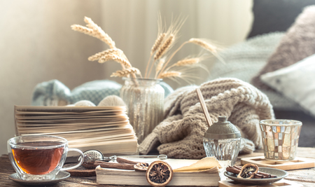 Still life details of home interior on a wooden table with a Cup of tea, the concept of coziness and home atmosphere .Living roomの写真素材