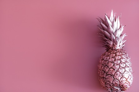 Golden colored pineapple on a colored background, creative advertising design.Top viewの写真素材