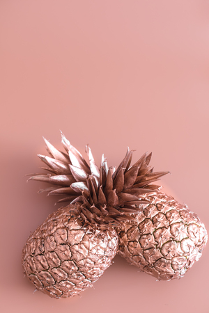Golden colored pineapple on a colored background, creative advertising design.Top viewの写真素材