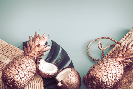 Summer tropical background with Golden pineapple and summer accessories with heart-shaped glasses, pastel background, creativity and style conceptの写真素材