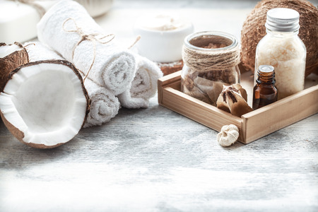 Spa still life with fresh coconut and body care products on light background, spa therapy conceptの写真素材