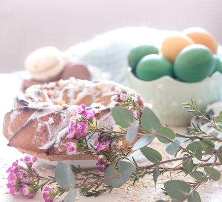 Composition with Easter sweet cake and eggs with flowers on a light background, the concept of the holidayの写真素材