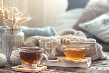 Still life details of home interior on a wooden table with a Cup of tea, the concept of coziness and home atmosphere .Living roomの写真素材