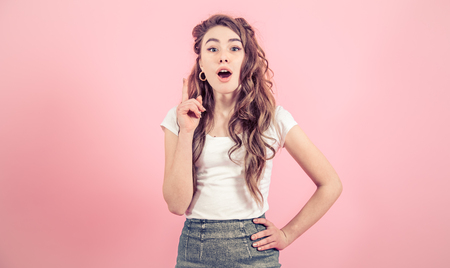 Portrait of a young girl with long hair on a colored background, space for textの写真素材