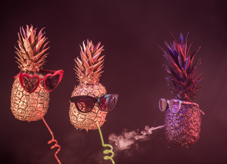 club concept ,black and gold pineapples in sunglasses, drink cocktail with straw and smoke hookah on black isolated background, Studio shooting, creative and artの写真素材