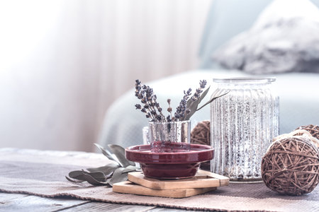 still life with various details of a cozy home interior , against the background of a sofa with...