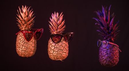 creative pineapples gold and black with glasses on a black background, Studio photography , creative idea, space for textの写真素材