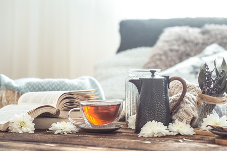 Still life details of home interior on a wooden table with a Cup of tea, the concept of coziness and home atmosphere .Living roomの写真素材