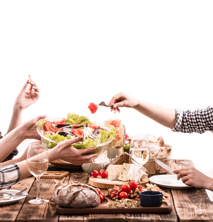 A group of friends at the table with fresh organic food, the concept of celebration and healthy eatingの写真素材