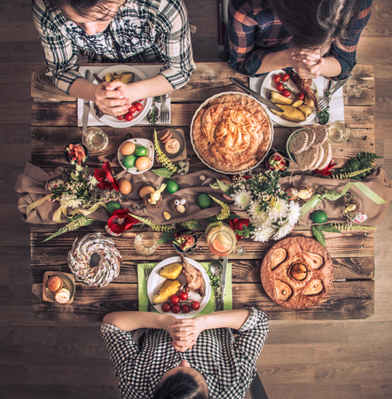 A traditional celebration of the Passover, the feast of the Passover. Apartment-holiday friends or family at the festive table top view. Friends pray in honor of Easter at the festive table.の写真素材