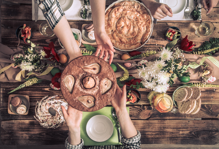 Home Celebration of friends or family at the festive Easter table with Easter cake, top view, celebration Conceptの写真素材