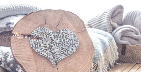 decorative heart of nails on a wooden background in the interior of the room . The concept of home comfort and designの写真素材