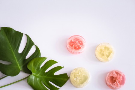 composition with tropical leaves and soap on a white background, the concept of care and beauty, top viewの写真素材