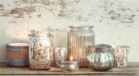 Home cozy beautiful decor, different vases and candles on a wooden background , the concept of interior detailsの写真素材