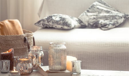 Still-life. Home cozy beautiful decor in the living room, vase and candles, on the background of a wooden table, interior details conceptの写真素材