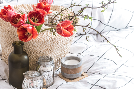 Objects of home cozy decor in the interior of the room .With beautiful red tulips .The concept of decor and home atmosphereの写真素材