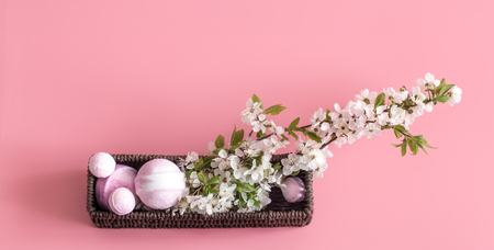 Spa still life on a pink background with spring flowers and organic body care products. The concept of Spa body careの写真素材
