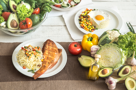 Organic healthy food at the light dining table in a homely atmosphere. The concept of healthy eating and home-cooked foodの写真素材