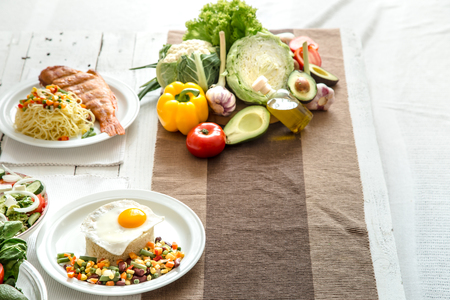 Organic healthy food at the light dining table in a homely atmosphere. The concept of healthy eating and home-cooked foodの写真素材