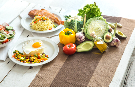 Organic healthy food at the light dining table in a homely atmosphere. The concept of healthy eating and home-cooked foodの写真素材