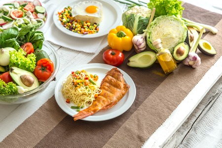 Organic healthy food at the light dining table in a homely atmosphere. The concept of healthy eating and home-cooked foodの写真素材
