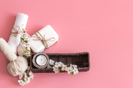 Spa still life on a pink background with spring flowers and organic body care products. The concept of Spa body careの写真素材