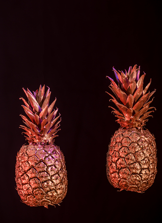 Golden pineapple on black isolated background, Studio shooting, creative and artの写真素材