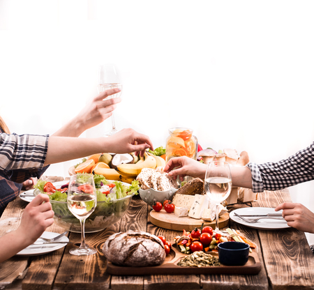 A group of friends at the table with fresh organic food, the concept of celebration and healthy eatingの写真素材