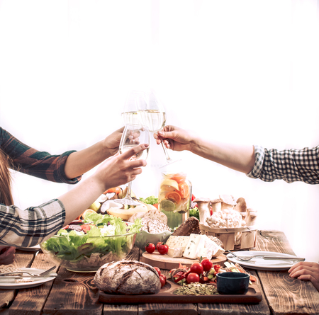 A group of friends at the table with fresh organic food, the concept of celebration and healthy eatingの写真素材