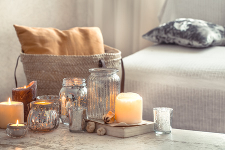 Still-life. Home cozy beautiful decor in the living room, vase and candles, on the background of a wooden table, interior details conceptの写真素材
