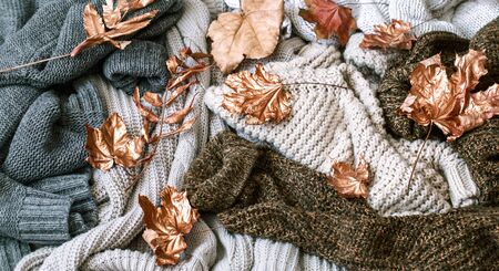 Cozy autumn morning breakfast in bed still life scene. Steaming cup of hot coffee, tea standing near window. Fall, Thanksgiving concept. White pumpkins, pine cones and oak leaves on wool plaid.の写真素材