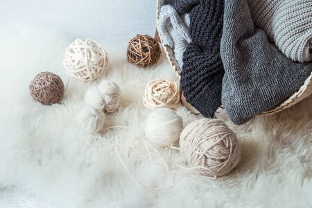 composition with knitted sweaters and a ball of thread, the concept of hobby and knittingの写真素材