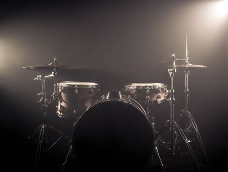 Drum Set On A Stage At Dark Background. Musical Drums Kit On Stage. Vintage look with smoke effectの写真素材