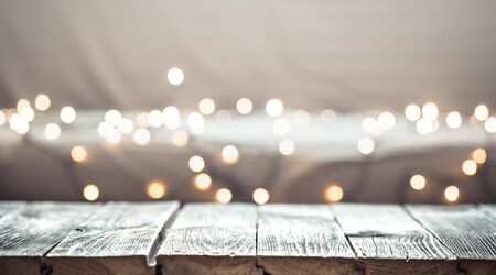 Christmas holiday background with empty wooden table top over festive bokeh light decorate. For create montage product displayの写真素材