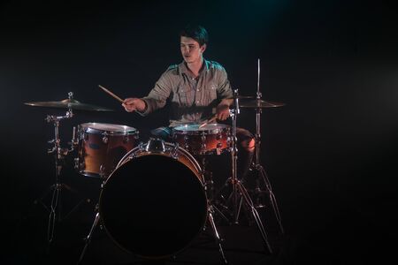 musician playing drums, black background and beautiful soft light, emotional play, music conceptの写真素材