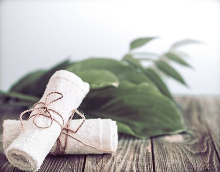 Spa and wellness setting with flowers and white towels. Dayspa nature productsの写真素材