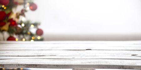 Christmas holiday background with empty wooden table top over festive bokeh light decorate. For create montage product displayの写真素材