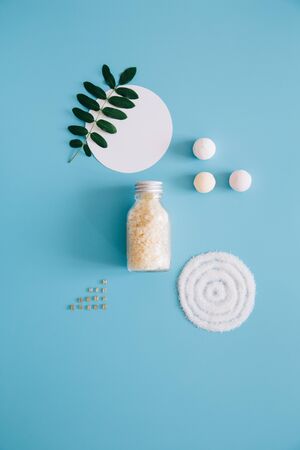 Mockup Spa bottles with bath salt on blue background. Concept natural organic cosmetics, homeopathic cosmetology. Copy spaceの写真素材