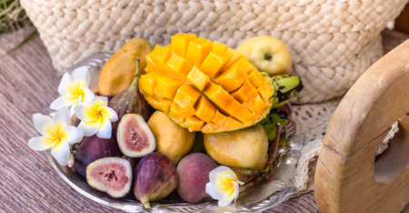 A plate of assorted fruits, sliced mango. The view from the top .