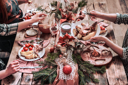 Flat-lay of friends hands eating and drinking together. Top view of people having party, gathering,...