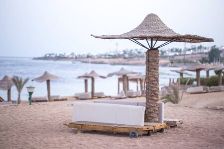 Empty beautiful beach with umbrellas and sunbeds in Egypt . the concept of travel and recreation .の写真素材
