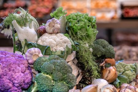 Display of fresh ripe organic broccoli, salad with greens and vegetables in cotton bag at the weekend farmer's market with blurred backgroundの写真素材