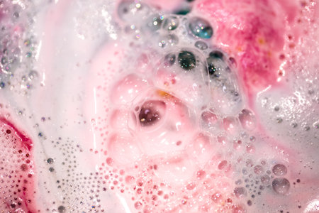 The bright bath bomb dissolves in water . The concept of body care . Handmade cosmetics .