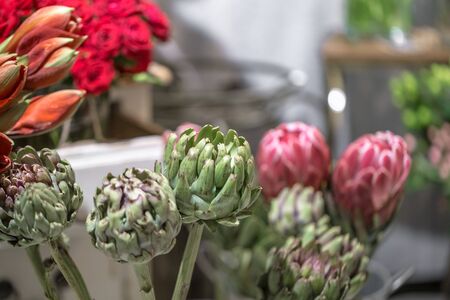 Exotic flowers are the red Amaryllis, artichoke and Protea flowers in a flower shop.の写真素材