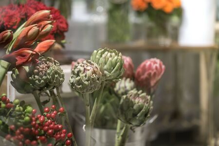 Exotic flowers are the red Amaryllis, artichoke and Protea flowers in a flower shop.の写真素材