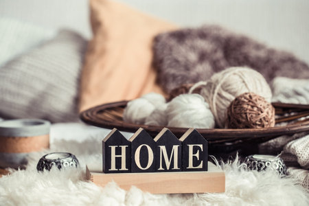 Still life home decor in a cozy house with wooden letters with the inscription home. The concept of...