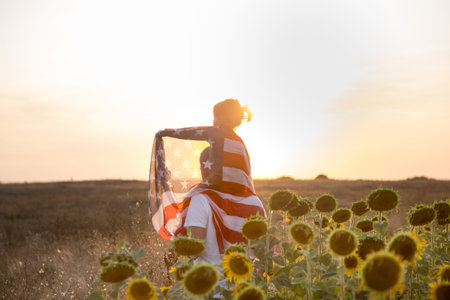 Happy family, dad and daughter holding the American flag at sunset. Dressed in white. The concept of...